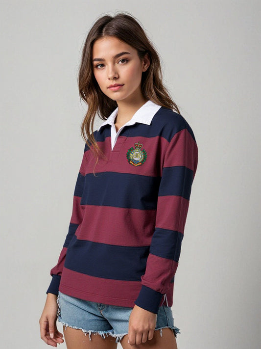 “A young female model wearing a women’s long-sleeve rugby shirt in alternating navy and burgundy horizontal stripes, featuring a white contrast collar, ribbed cuffed sleeves, and the Royal Engineers Logo embroidered on the left breast. Styled with denim cut-off shorts.”