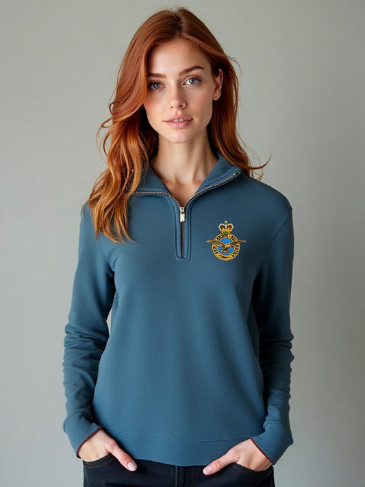 Female model wearing stone blue Royal Air Force quarter-zip sweatshirt with embroidered RAF crest – soft, military-style women’s pullover ideal for RAF veterans, supporters, and casual wear.