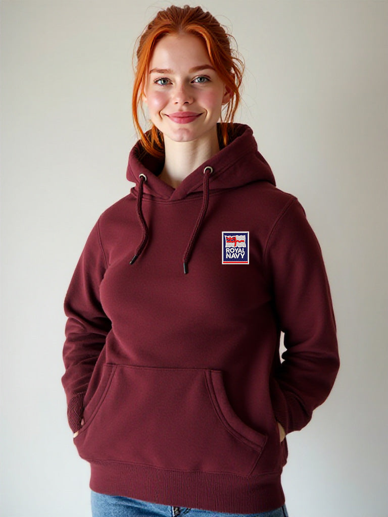 Female model wearing a maroon hoodie featuring the Royal Navy logo on the left chest, hands in pockets, photographed indoors.