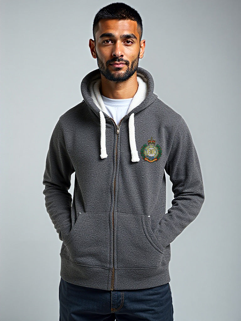 Man wearing a black melange zip-up hoodie with Royal Engineers crest, hands in pockets, facing forward against a plain backdrop.