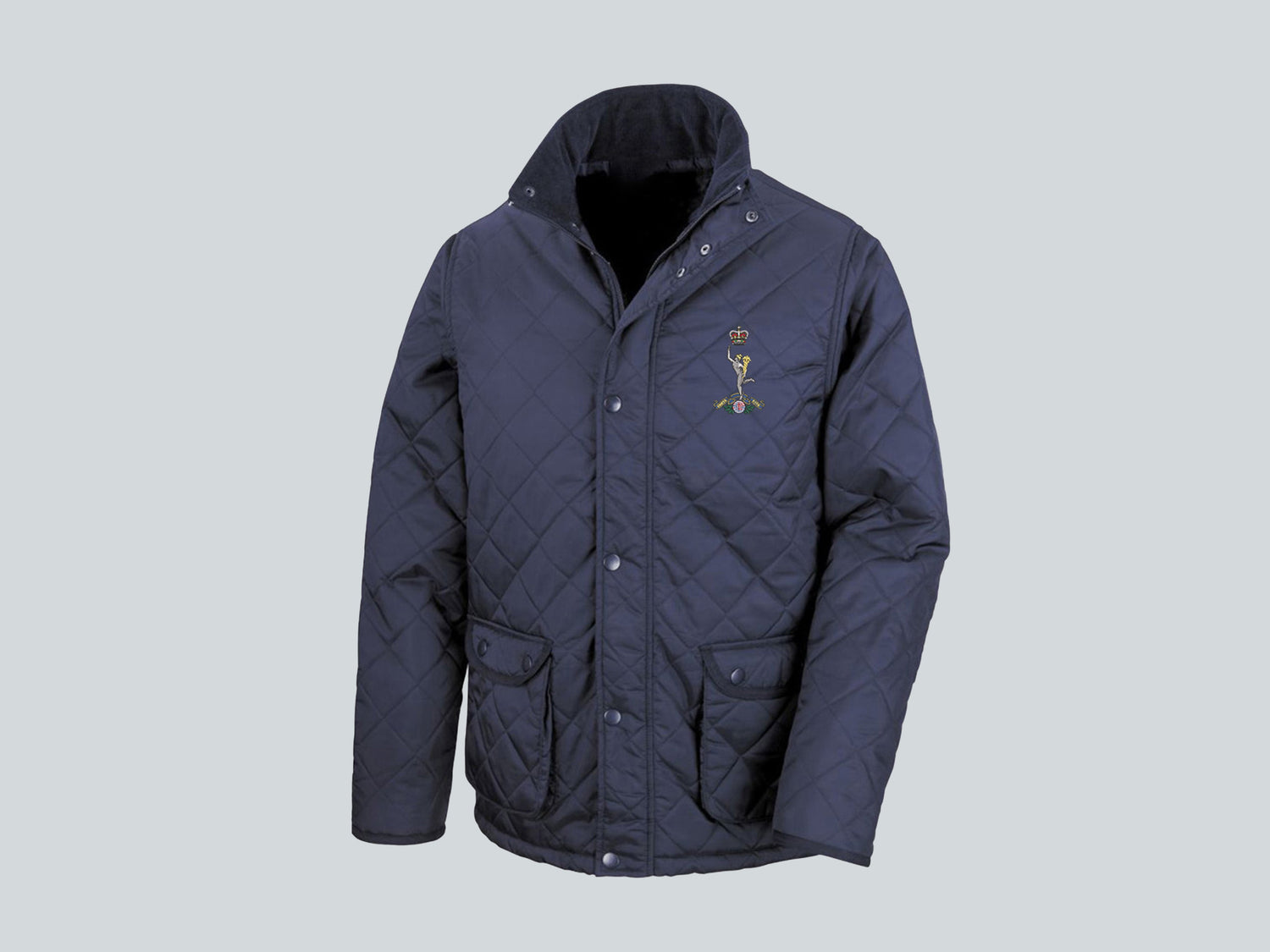 Navy blue Royal Signals quilted jacket featuring premium embroidered Royal Signals crest, durable military outerwear for British Army veterans and serving personnel.