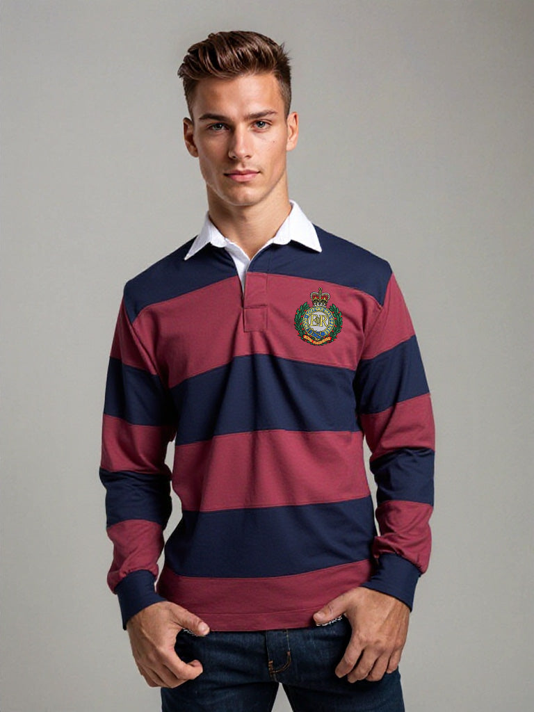 “A male model wearing a classic men’s rugby shirt with navy and burgundy wide horizontal stripes, white contrast collar, button-placket front, cuffed sleeves, and the Royal Engineers Logo embroidered on the left breast. Paired with dark wash jeans.”