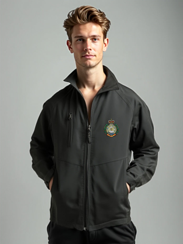 “Tall male model wearing a men’s Royal Engineers black softshell jacket with stand-up collar, full-length front zipper, chest zip pocket, side hand pockets and Royal Engineers Logo embroidered on left breast.”