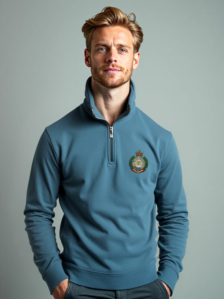 Male model in stone blue Royal Engineers half zip sweatshirt with embroidered crest, official MOD licensed men’s quarter zip pullover with stand-up collar, British Army design.