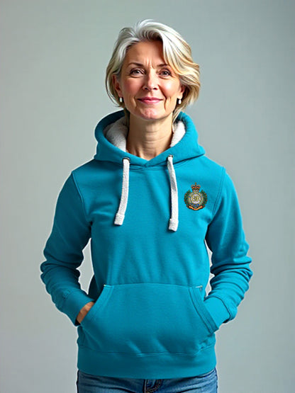 Woman wearing a tropical blue hoodie with a Royal Engineers crest on the left chest, white drawstrings, and a front pouch pocket, standing against a neutral grey background.