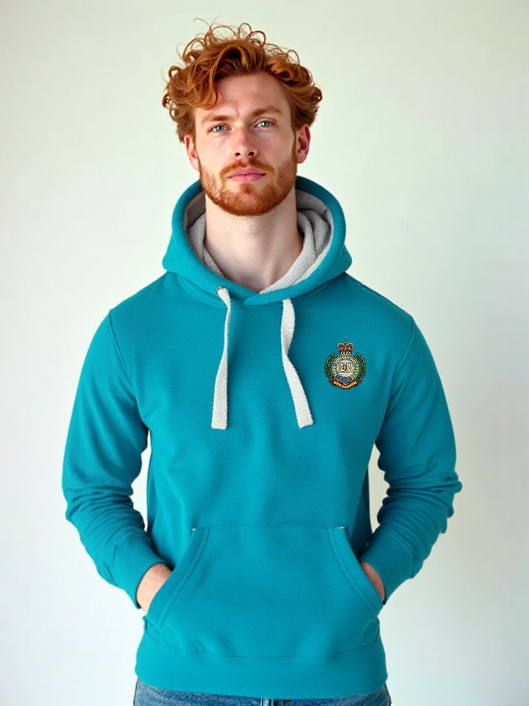 Man wearing a tropical blue hoodie with a Royal Engineers crest on the left chest, white drawstrings, and a front pouch pocket, standing against a neutral grey background.