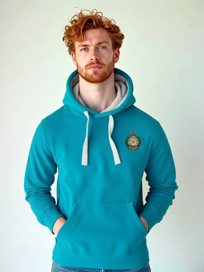 Man wearing a tropical blue hoodie with a Royal Engineers crest on the left chest, white drawstrings, and a front pouch pocket, standing against a neutral grey background.