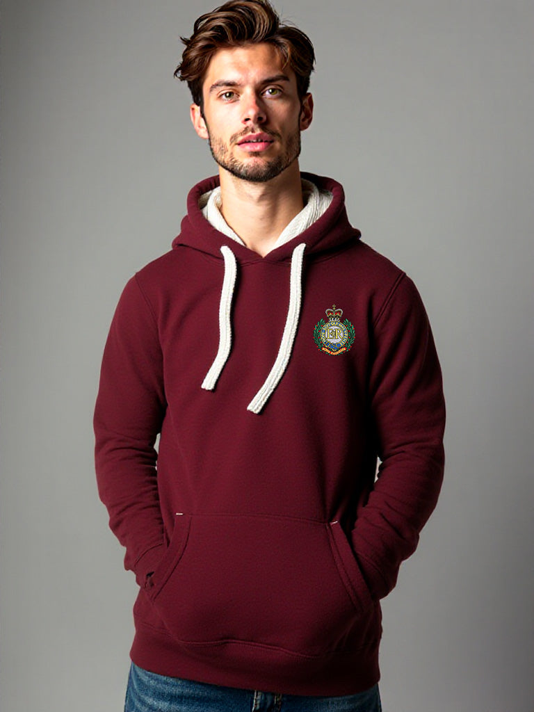 Man wearing a maroon hoodie with a Royal Engineers crest on the left chest, white drawstrings, and a front pouch pocket, standing against a neutral grey background.