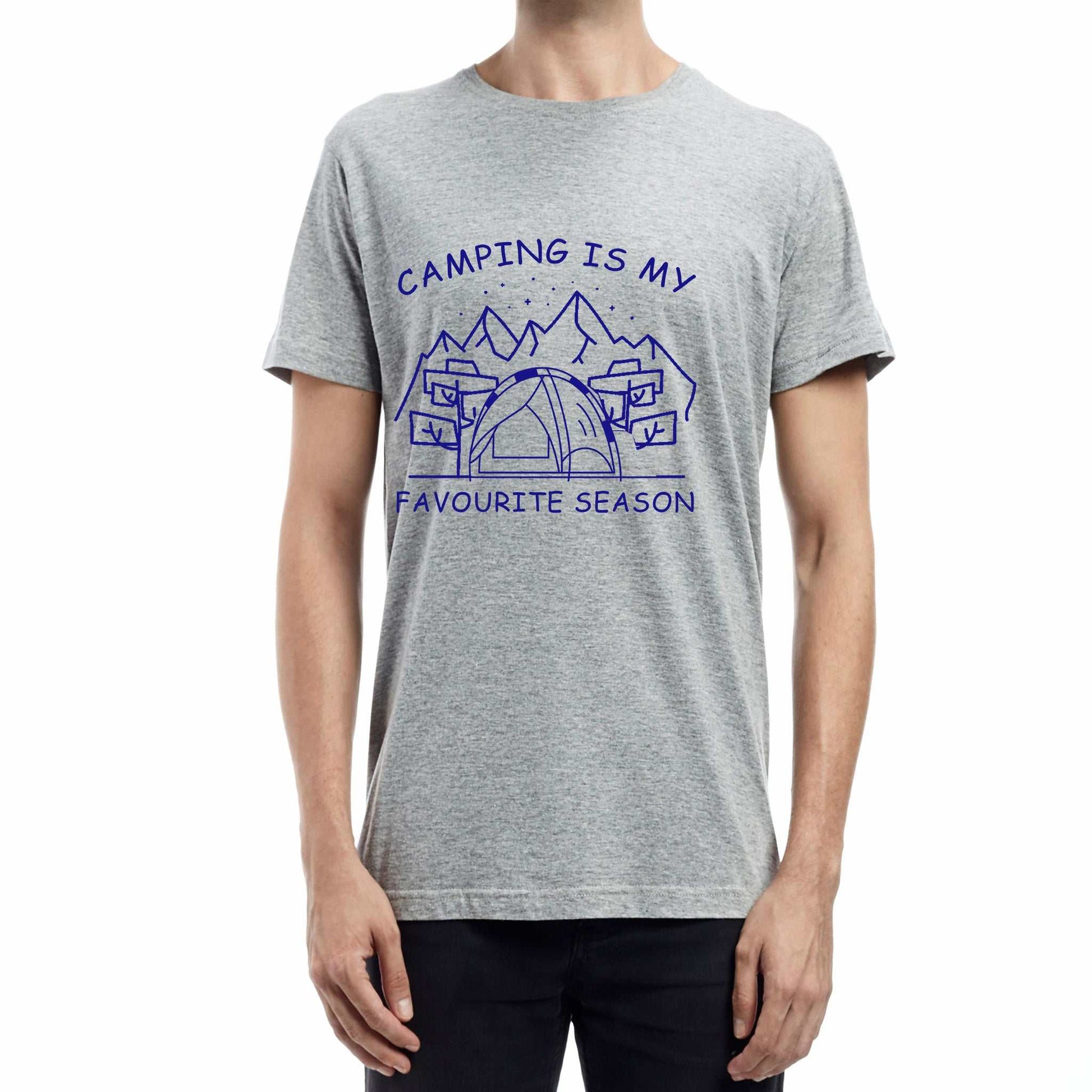  "Grey Graphic tee with an illustration of a tent, surrounded by nature. Text reads: 'Camping is my favorite season.' Celebrate the great outdoors!"