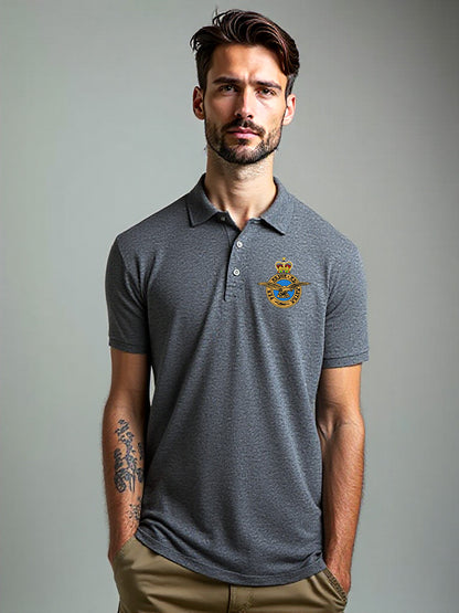 Male model in charcoal grey Royal Air Force polo shirt featuring embroidered RAF crest – smart-casual military apparel for RAF enthusiasts, veterans, and everyday wear.