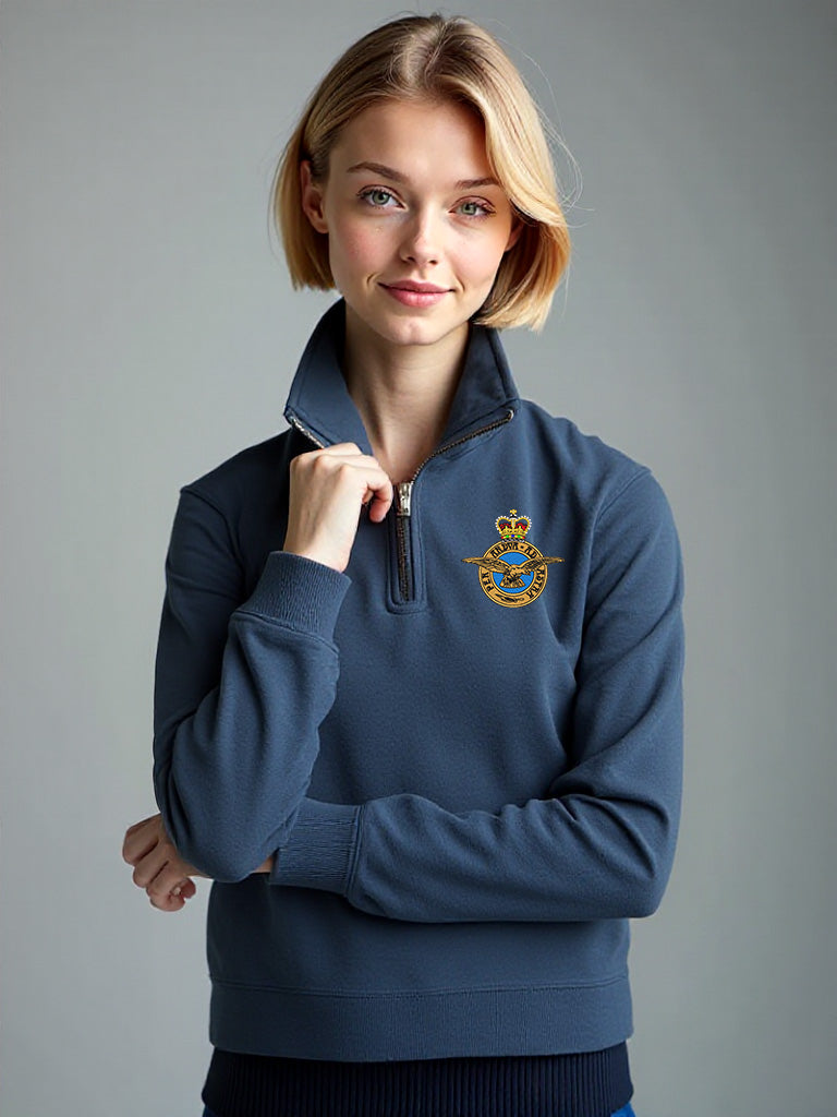 Female model wearing stone blue Royal Air Force quarter-zip sweatshirt with embroidered RAF crest – cozy military-style pullover for RAF supporters, veterans, and casual everyday wear.