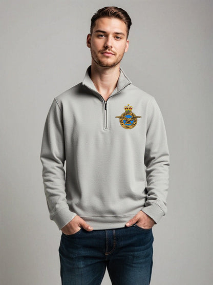 Male model wearing light grey Royal Air Force quarter-zip sweatshirt with embroidered RAF crest – stylish and comfortable military-inspired pullover for RAF veterans, personnel, and supporters.