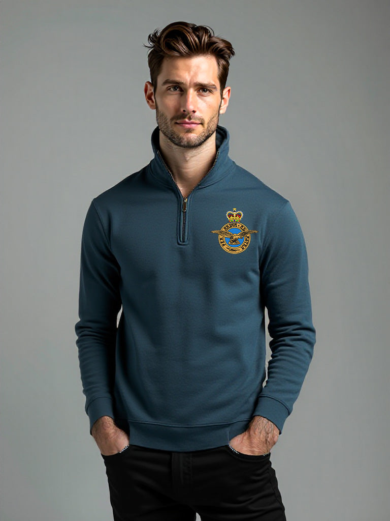 Male model wearing stone blue Royal Air Force quarter-zip sweatshirt with embroidered RAF crest – casual military-inspired pullover for veterans, RAF personnel, and aviation supporters.
