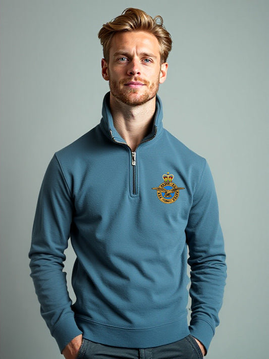 Male model wearing stone blue Royal Air Force quarter-zip sweatshirt with embroidered RAF crest – high-quality military-inspired pullover for RAF supporters, veterans, and casual wear.