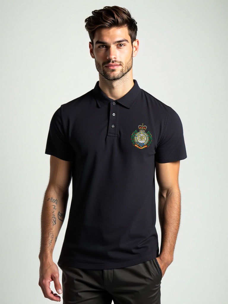 Male model wearing black Royal Engineers polo shirt featuring embroidered military crest on front left chest, short sleeve design with button-up collar, Sapper logo printed on the back.