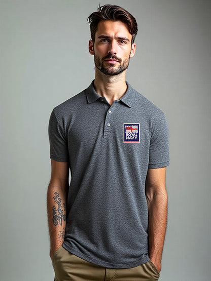 Men’s charcoal grey Royal Navy polo shirt featuring official embroidered Royal Navy badge. Modern slim-fit design ideal for veterans, service personnel, and supporters. Breathable cotton-blend fabric with button-up collar for casual and smart wear.