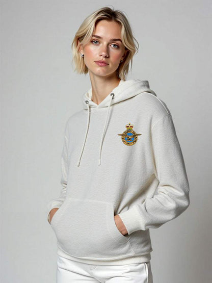 Female model wearing white Royal Air Force hoodie with embroidered RAF crest, official women’s pullover with drawstring hood and front pocket, RAF military hoodie in white.