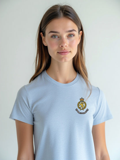 Female model in a sky blue WRAC t-shirt, showcasing the embroidered WRAC crest on the left chest, in a light and neutral background.
