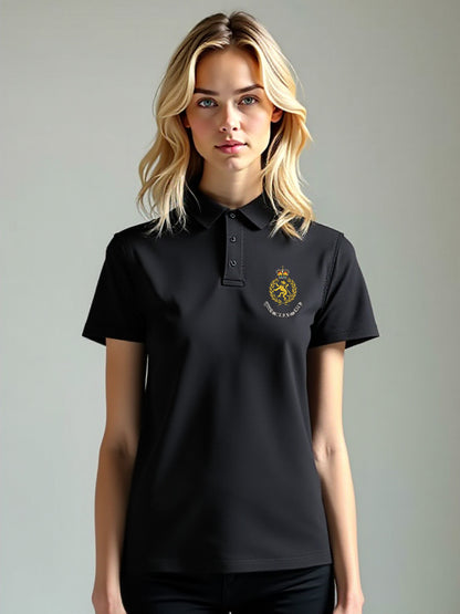 Female model in a black WRAC polo shirt featuring an embroidered WRAC badge on the left chest, standing in a clean, simple setting.