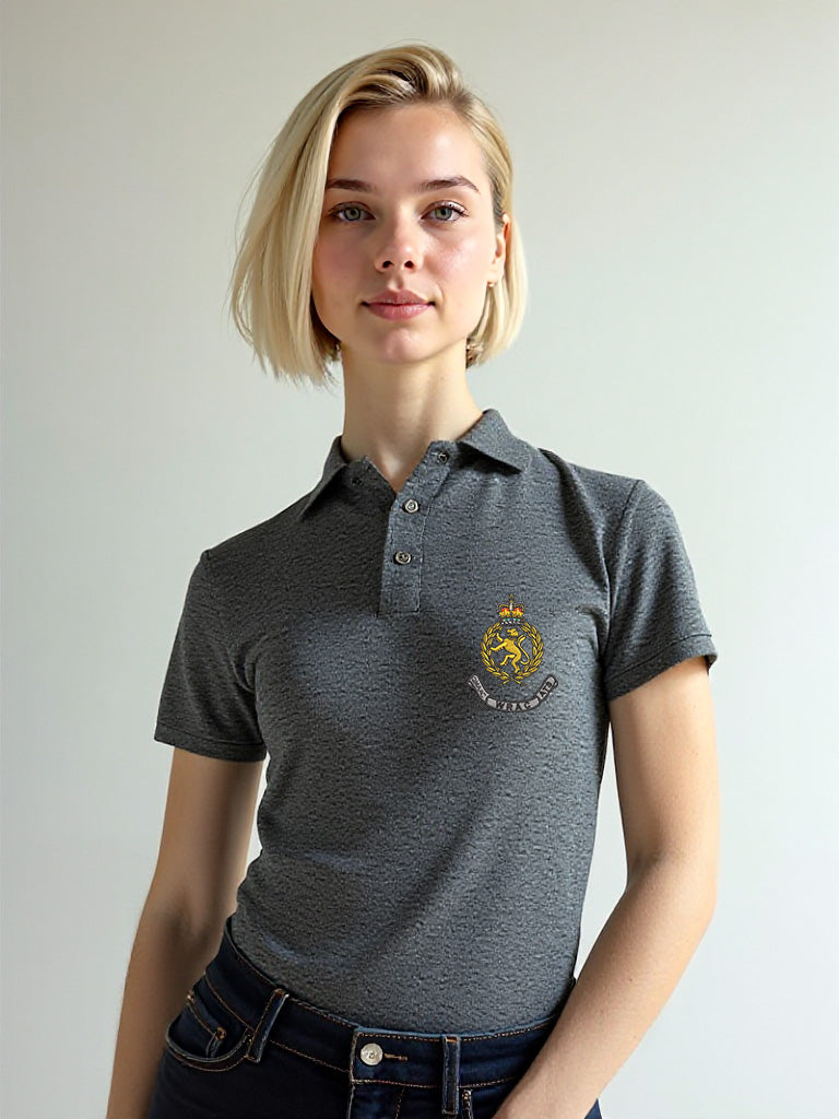 Female model dressed in a charcoal WRAC polo shirt with the WRAC crest stitched on the left chest, shown in a casual pose.