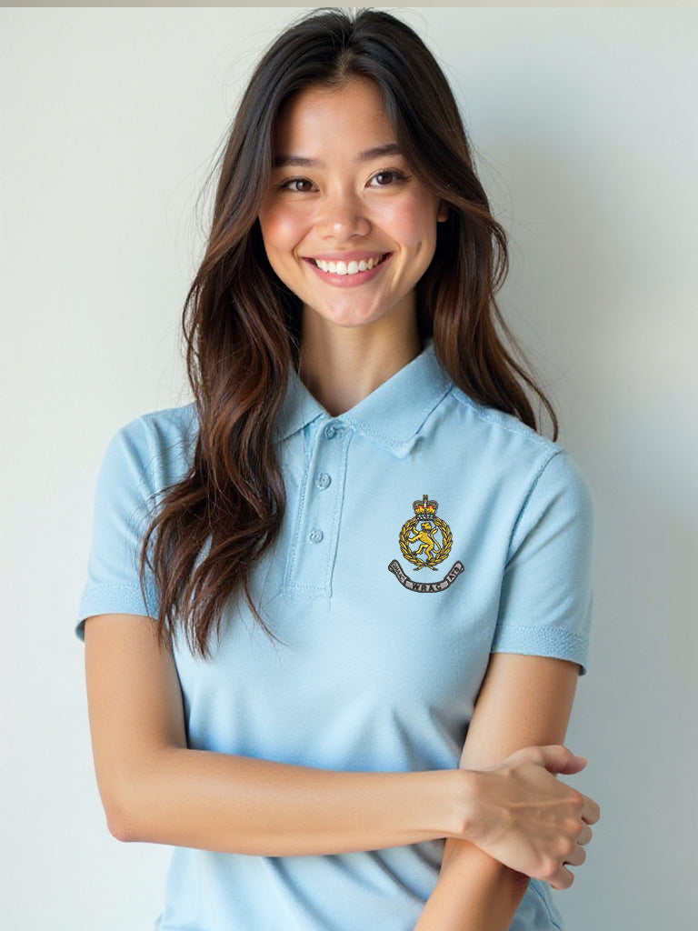 Female model dressed in a sky blue WRAC polo shirt with the WRAC badge on the left chest, posed with a relaxed expression.