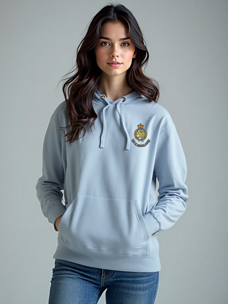 Female model wearing a sky blue WRAC hoodie with the WRAC badge stitched on the left chest, styled with a soft, neutral background.